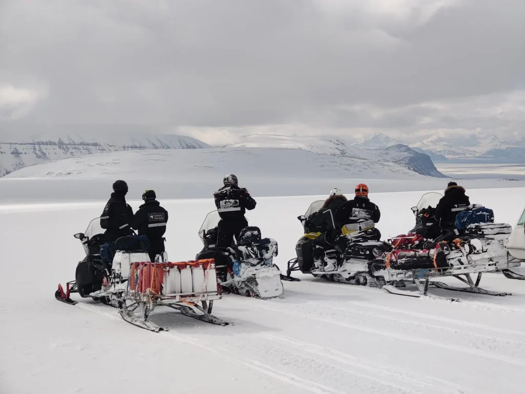 Ride a snowmobile to an ice cave in Svalbard