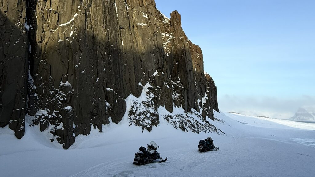 Experience the beautiful scenary in Svalbard on a snowmobile tour with ice climbing