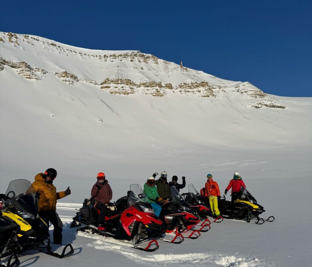 We go with snowmobile to reach our ski camp destination on Svalbard