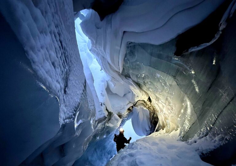 Visit an ice cave on Svalbard with just a snowmobile ride away