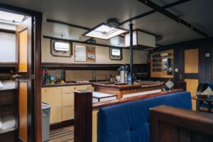 The interior view of the kitchen area and dining salon aboard the expedition ship Saeftinghe in Svalbard