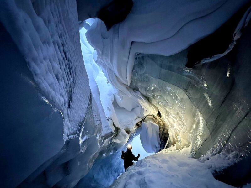 A traveller in an ice cave on Svalbard