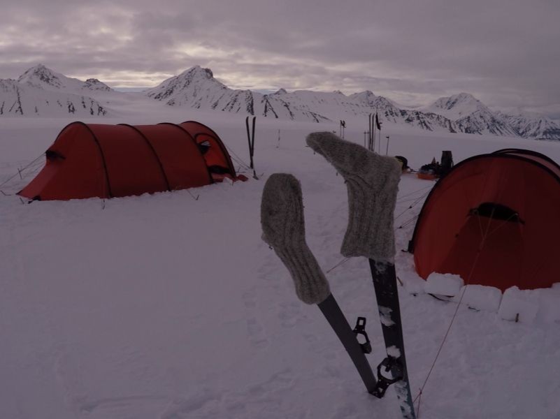 The camp with the red tents are ready after a day ski crossing from coast to coast on Svalbard
