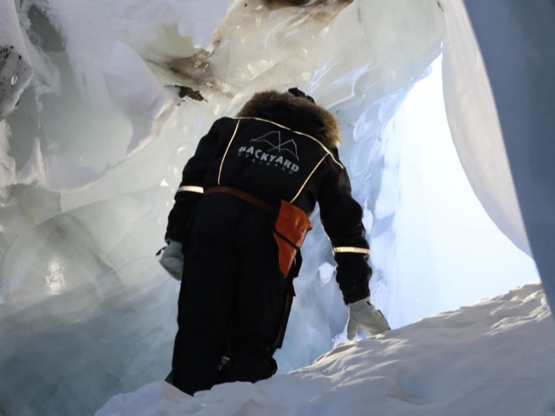 Wearing snowmobile suit in the ice cave beneath a Svalbard glacier