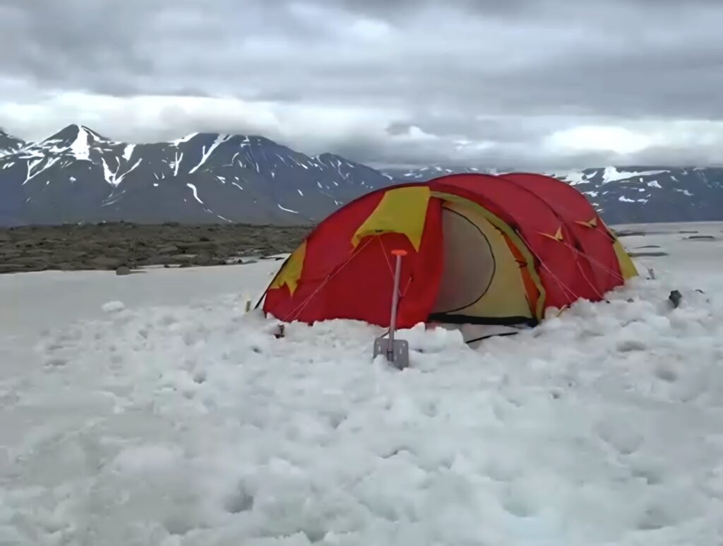 Red tent pitched in Svalbars wilderness under a 2 day Wilderness Camp trip on Svalbard