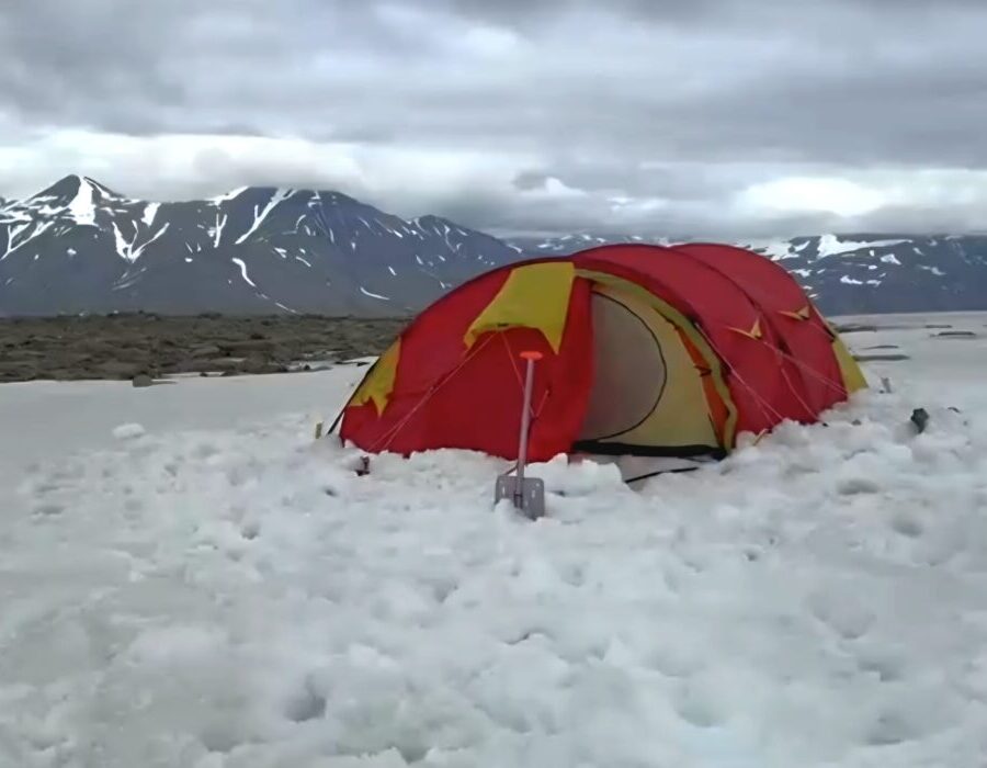 Red tent pitched in Svalbars wilderness under a 2 day Wilderness Camp trip on Svalbard
