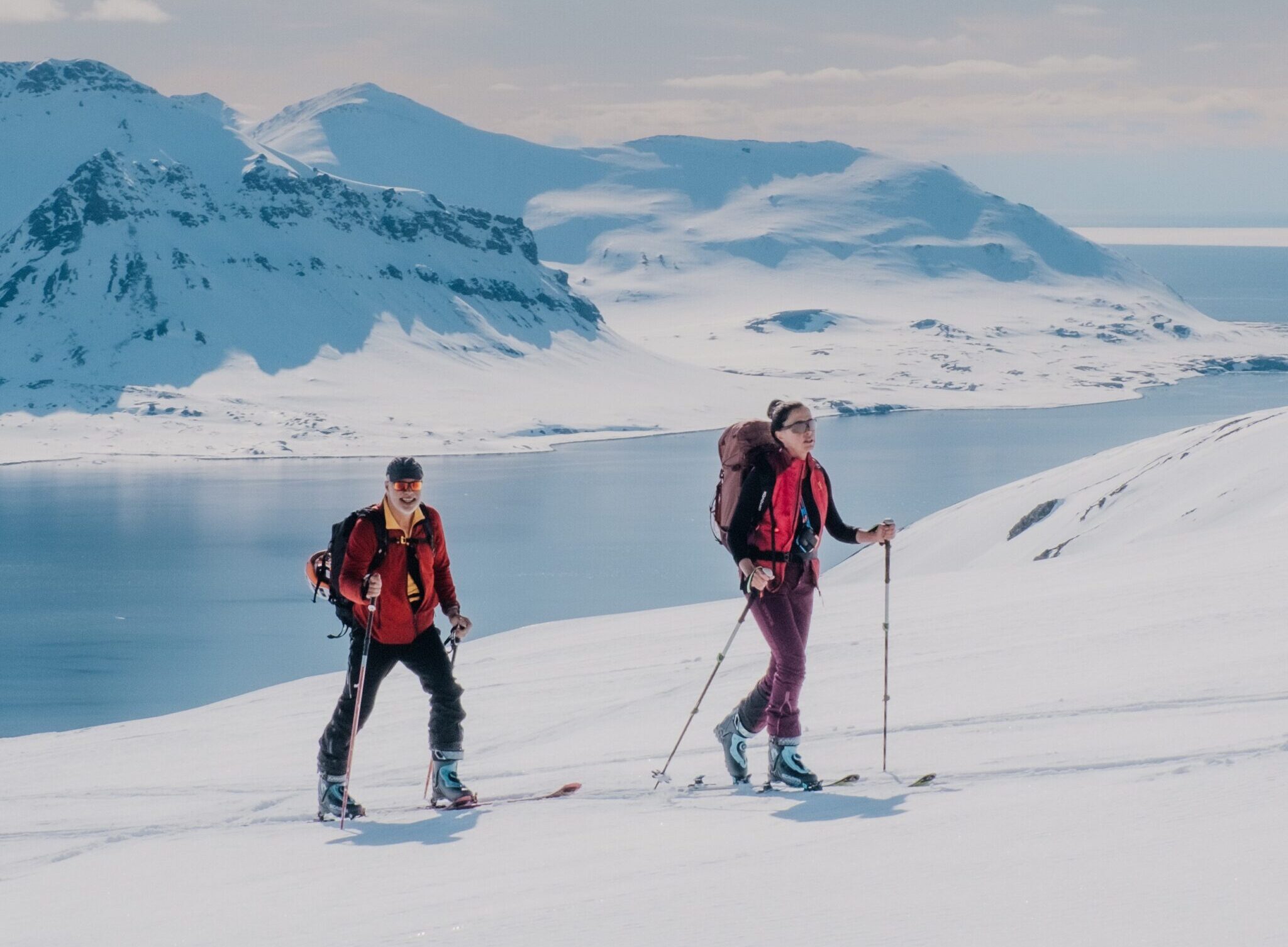 Skiers on a snowcovered mountain in Svalbard