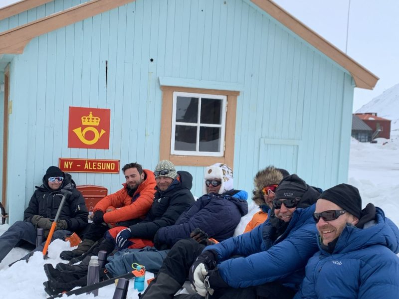 Skiiers enjoying their arrival to Ny-Ålesund after 7-days ski crossing across Oscar II Land in Svalbard